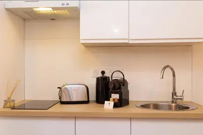 a kitchen counter with a toaster and a sink at Le Petit Capoine 2- T2 Plein Centre de Carcassonne- in Carcassonne
