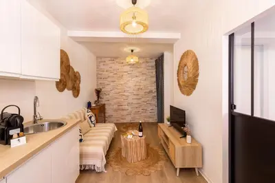 a kitchen with a couch in the middle of a room at Le Petit Capoine 2- T2 Plein Centre de Carcassonne- in Carcassonne