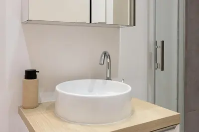 a bathroom with a white sink and a mirror at Le Petit Capoine 2- T2 Plein Centre de Carcassonne- in Carcassonne