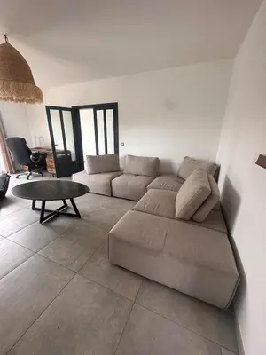 a living room with a couch and a table at House with garden near Castres city center in Castres