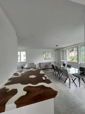 a bedroom with a large bed and a dining room at House with garden near Castres city center in Castres