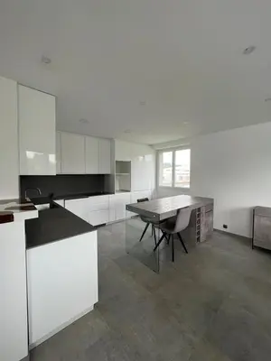 a white kitchen with a table and a table sidx sidx sidx sidx at House with garden near Castres city center in Castres
