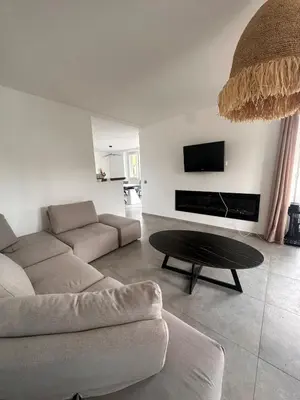 a living room with a couch and a coffee table at House with garden near Castres city center in Castres