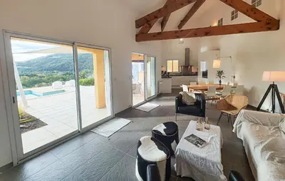 a living room with a large sliding glass door at Awesome Home In Roquebrun in Roquebrun