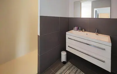 a bathroom with a sink and a mirror at Awesome Home In Roquebrun in Roquebrun