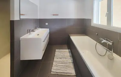 a bathroom with a bath tub and a sink at Awesome Home In Roquebrun in Roquebrun