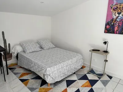a small bedroom with a bed and a table at Gutenberg's Nest in Carcassonne