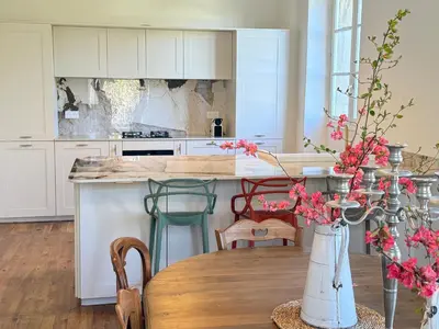 a building with stairs leading up to a door at La Maison Carrée - Escape to Timeless French Charm in Chalabre