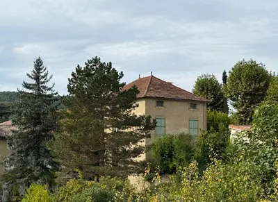 a bathroom with a shower with blue and brown tiles at La Maison Carrée - Escape to Timeless French Charm in Chalabre