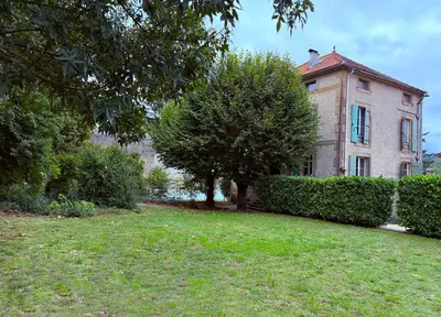 a hallway with a chandelier and a door to a driveway at La Maison Carrée - Escape to Timeless French Charm in Chalabre