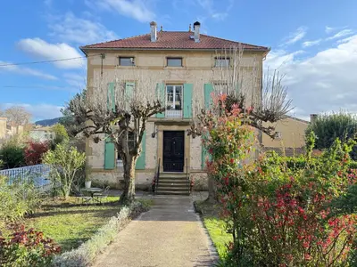 a ping pong table in a living room with a couch at La Maison Carrée - Escape to Timeless French Charm in Chalabre