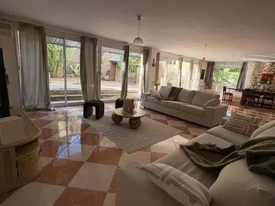 a living room with a couch and a table at La Villa Narbo Martius in Ornaisons
