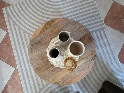 two cups of coffee sitting on a wooden table at La Villa Narbo Martius in Ornaisons