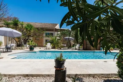 a swimming pool in a yard with a house at La Villa Narbo Martius in Ornaisons