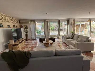 a living room with a couch and a table at La Villa Narbo Martius in Ornaisons