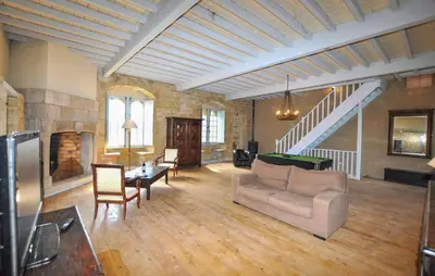 a large living room with a couch and a fireplace at Apaisante Maison Authentique in Sainte-Foi
