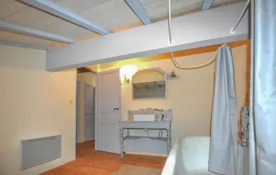a bedroom with a bed and a sink in a room at Apaisante Maison Authentique in Sainte-Foi