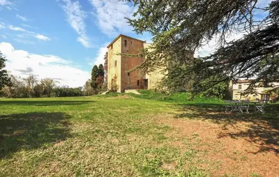 an old building in a field with a tree at Apaisante Maison Authentique in Sainte-Foi