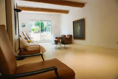 a living room filled with furniture and a window at Le séminaire in Fitou