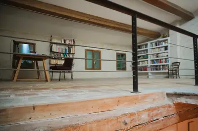 an empty room with a table and chairs and bookshelves at Le séminaire in Fitou
