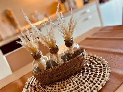 a basket with three glass bottles on a table at Le Cosy Vignes - Piscine partagée in Azille