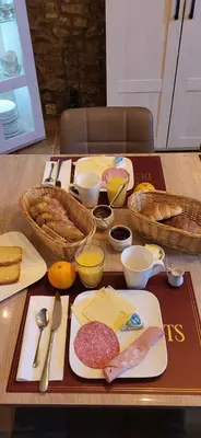a table topped with food and bread on a table at La maison millesime in La Caunette