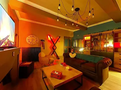 a living room with a couch and a table at Love Room CHARME et PLAISIRS in Mazamet