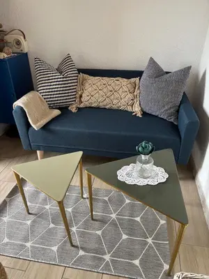 a living room with a blue couch and a table at Duplex plage des chalets Gruissan plage in Gruissan