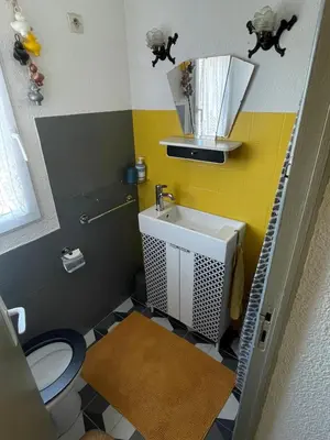 a small bathroom with a toilet and a sink at Duplex plage des chalets Gruissan plage in Gruissan
