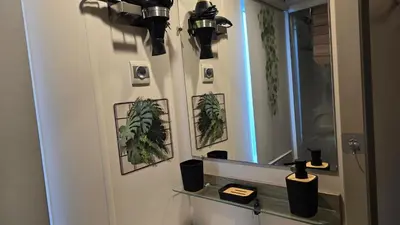 a bathroom with a mirror and plants on the wall at ZEN Mobil Home Occitanie 6P Tout confort & Climatisation in Port-la-Nouvelle