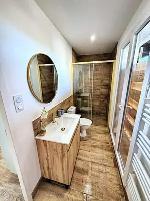 a bathroom with a sink and a toilet and a mirror at Studio à l'écurie 2 in Narbonne