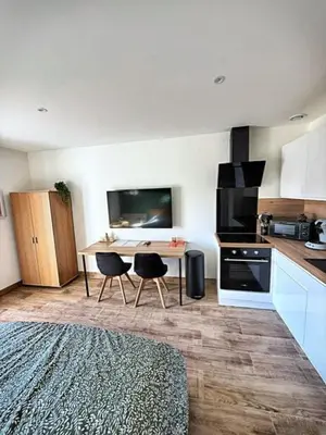 a kitchen with a table and chairs in a room at Studio à l'écurie 2 in Narbonne