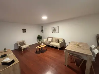a living room with a couch and a table at Maison cosy et chaleureuse in Pont-de-Larn