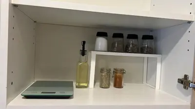 a white cabinet with a laptop and some spices at Charming apartment with terrace and parking in Carcassonne in Carcassonne