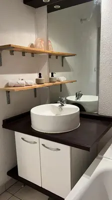 a bathroom with a sink and a mirror at Charming apartment with terrace and parking in Carcassonne in Carcassonne