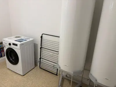 a washer and dryer in a room with a wall at La Parenthèse Carcassonnaise in Carcassonne