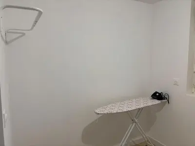 a table in a room with a white wall at La Parenthèse Carcassonnaise in Carcassonne