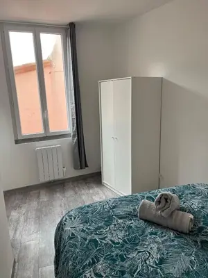 a bedroom with a bed with a teddy bear on it at Le Soult l Rénové l Stationnement facile & gratuit in Mazamet