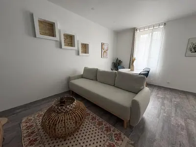 a living room with a couch and a table at Le Soult l Rénové l Stationnement facile & gratuit in Mazamet