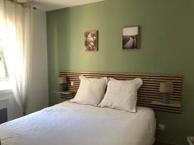 a bedroom with a white bed with two pillows at Maison d'hôtes à Castres-Saïx in Saix