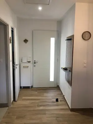 a hallway with a white door and a refrigerator at Maison d'hôtes à Castres-Saïx in Saix