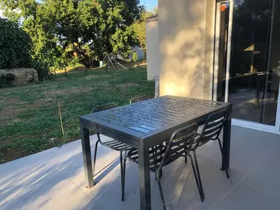 a black table and chairs sitting on a porch at Maison d'hôtes à Castres-Saïx in Saix