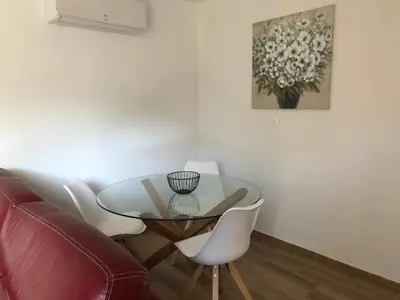 a dining room with a glass table and white chairs at Maison d'hôtes à Castres-Saïx in Saix