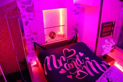 a bathroom with a tub with a green light at Loveroom, La Tour Secrete Jacuzzi, Sauna, plage, Clim, Netflix, Wifi Aude, occitanie in Vinassan