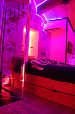 a table with two plates of food and candles on it at Loveroom, La Tour Secrete Jacuzzi, Sauna, plage, Clim, Netflix, Wifi Aude, occitanie in Vinassan