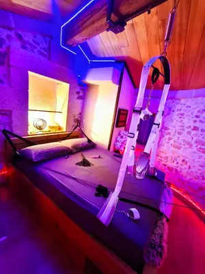 a large pool of blue water in a room with a lamp at Loveroom, La Tour Secrete Jacuzzi, Sauna, plage, Clim, Netflix, Wifi Aude, occitanie in Vinassan