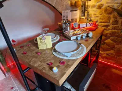 a bedroom with a bed with purple lights at Loveroom, La Tour Secrete Jacuzzi, Sauna, plage, Clim, Netflix, Wifi Aude, occitanie in Vinassan