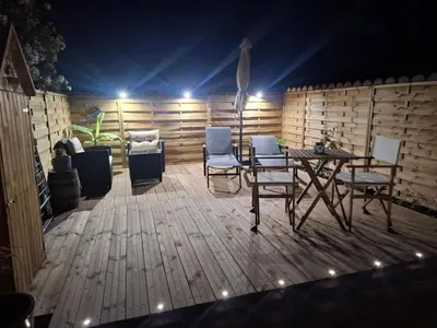 a patio with chairs and a table in a room at Gîte de la Trémiére in Salles-d'Aude