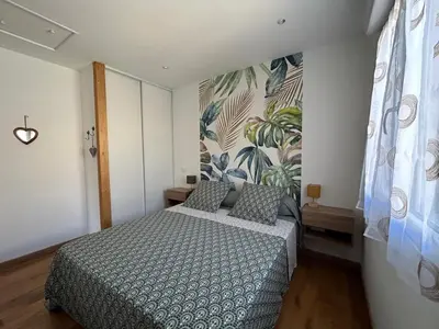 a bedroom with a bed and a mural on the wall at Gîte de la Trémiére in Salles-d'Aude