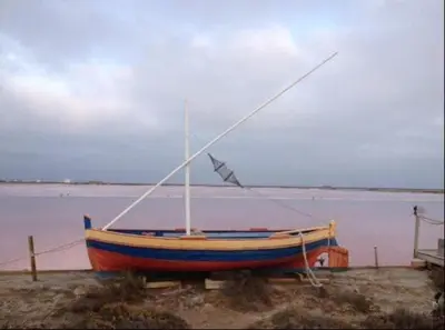 a boat sitting on the ground next to the water at Gîte de la Trémiére in Salles-d'Aude